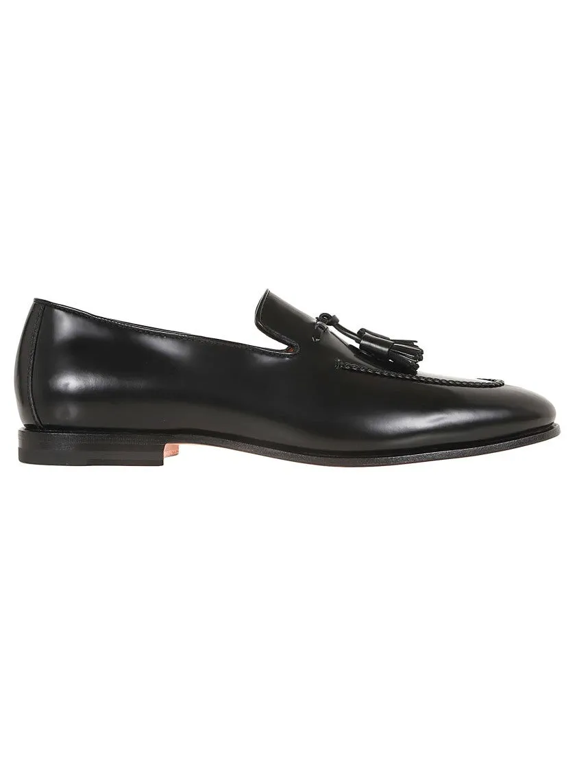 Black Leather Moccasin With Tapered Toe And Decorative Tassels